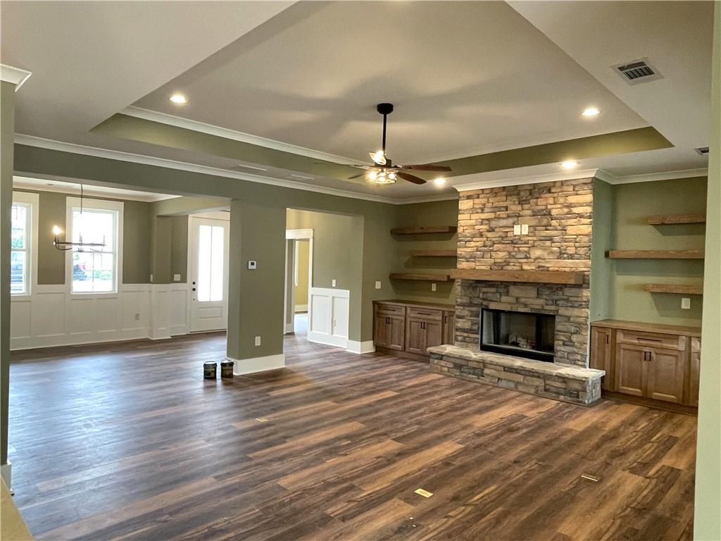 500 Mill Farm Lane Monroe, GA 30655 - Photo 9 of 35 an empty room with fireplace wooden floor and windows