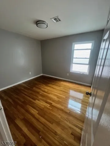 a view of room with window and hardwood floor