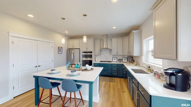 a kitchen with a sink appliances and cabinets