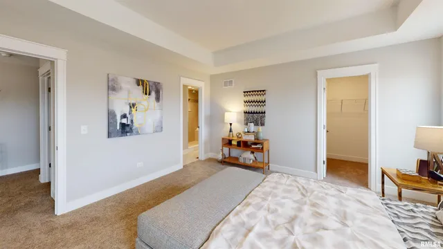 a bed room with a bed and a chair