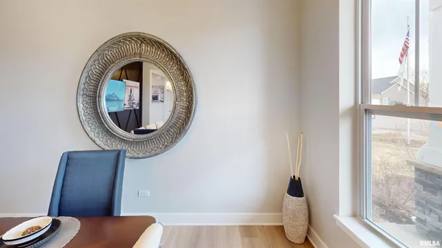 a view of a livingroom with furniture wooden floor and a window