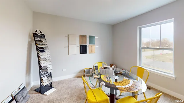 a view of a dining room with furniture and window