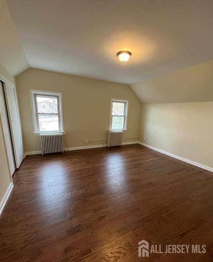 1061 King Georges Post Road Edison, NJ 08837 - Photo 3 of 10 an empty room with wooden floor and windows