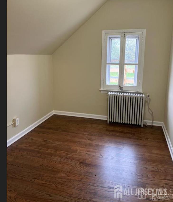1061 King Georges Post Road Edison, NJ 08837 - Photo 4 of 10 an empty room with wooden floor and windows
