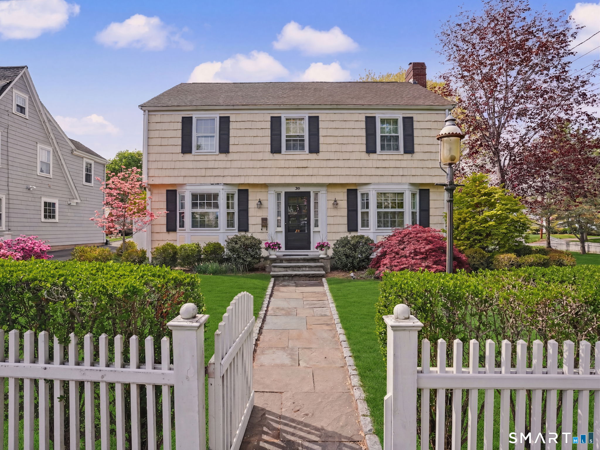 20 Chelsea Street Fairfield, CT 06824 - Photo 1 of 28 a front view of a house with yard and green space