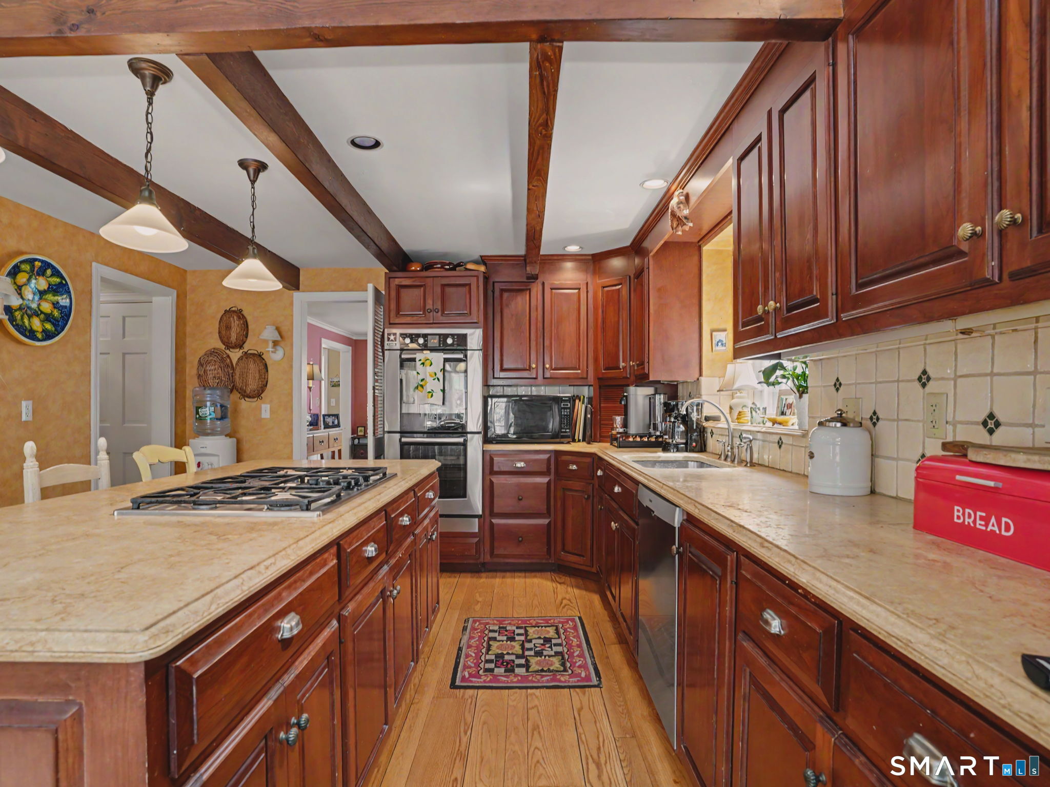 20 Chelsea Street Fairfield, CT 06824 - Photo 11 of 28 a kitchen with stainless steel appliances granite countertop a stove a sink dishwasher and cabinets with wooden floor