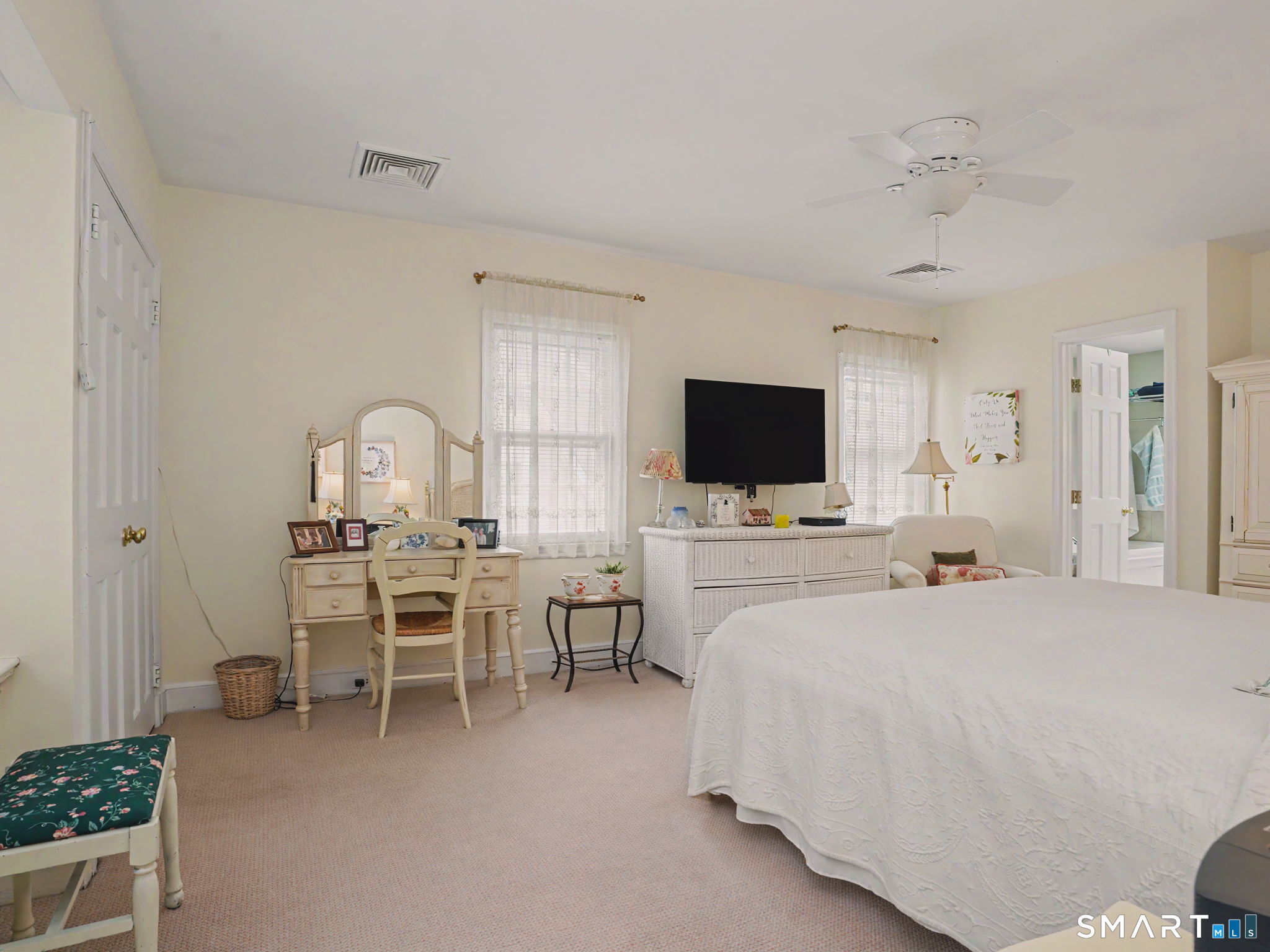 20 Chelsea Street Fairfield, CT 06824 - Photo 17 of 28 a large bedroom with a bed and a flat screen tv