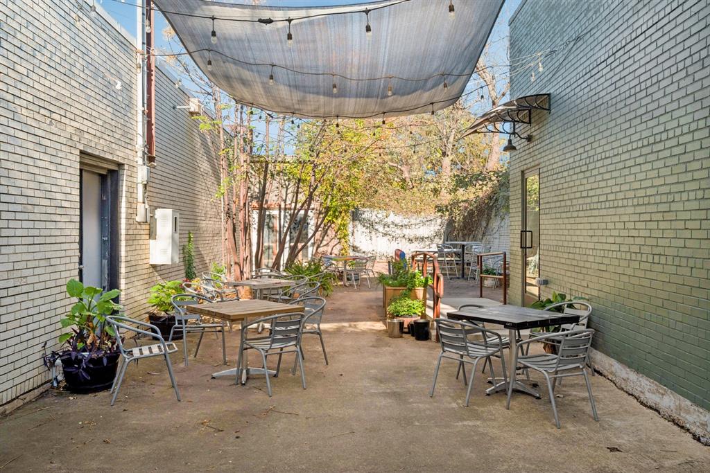 2016 South Ervay Street, Unit A2 Dallas, TX 75215 - Photo 29 of 35 a view of a patio with a table and chairs and potted plants