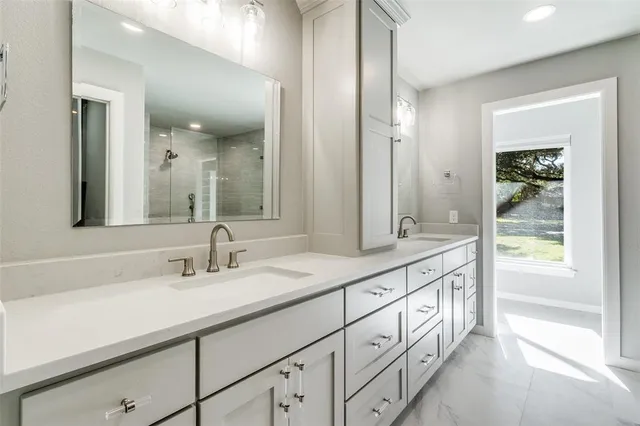 a bathroom with double sink and a mirror