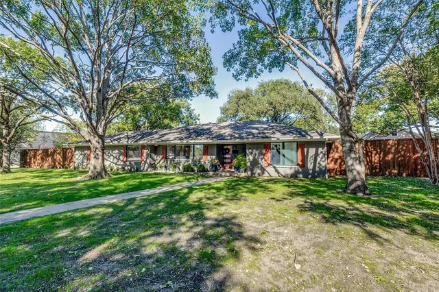 a backyard of a house with lots of green space and fountain