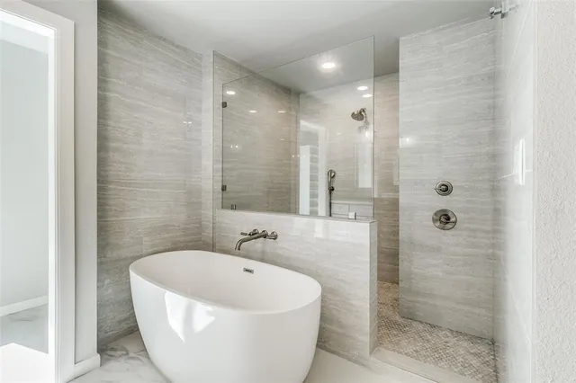 a bathroom with a bathtub and shower