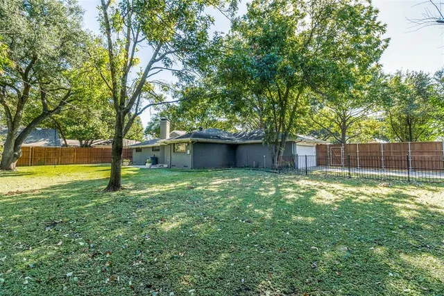 a backyard of a house with table and chairs