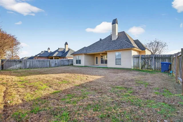 a house view with wooden fence