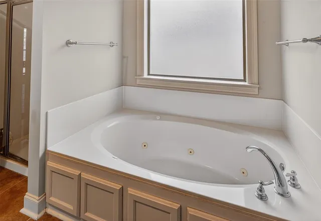 a bathroom with a bathtub and shower