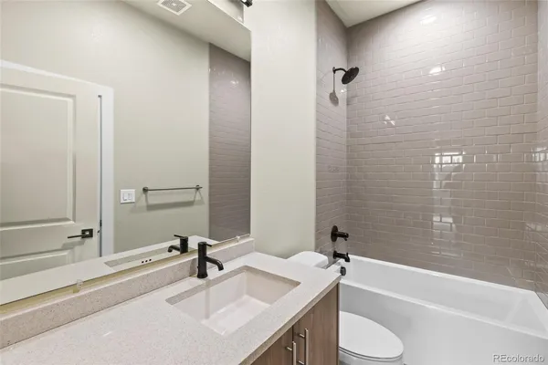 a bathroom with a sink a toilet and mirror