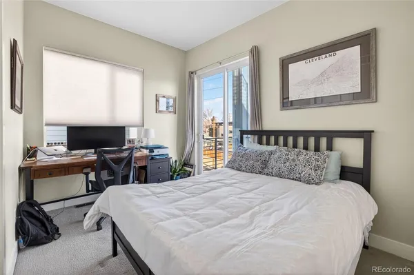 a bedroom with a bed and a mirror