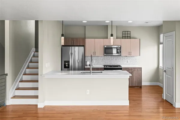 a view of kitchen with sink microwave and refrigerator