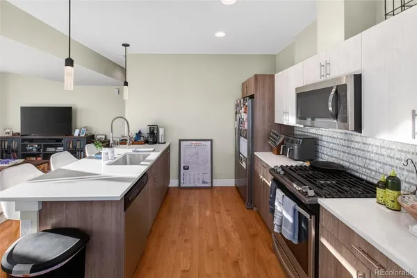 a kitchen with a sink stove and microwave