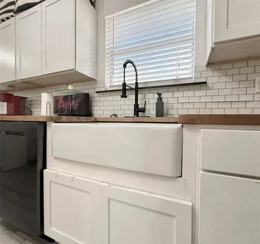 a kitchen with stainless steel appliances white cabinets and a sink
