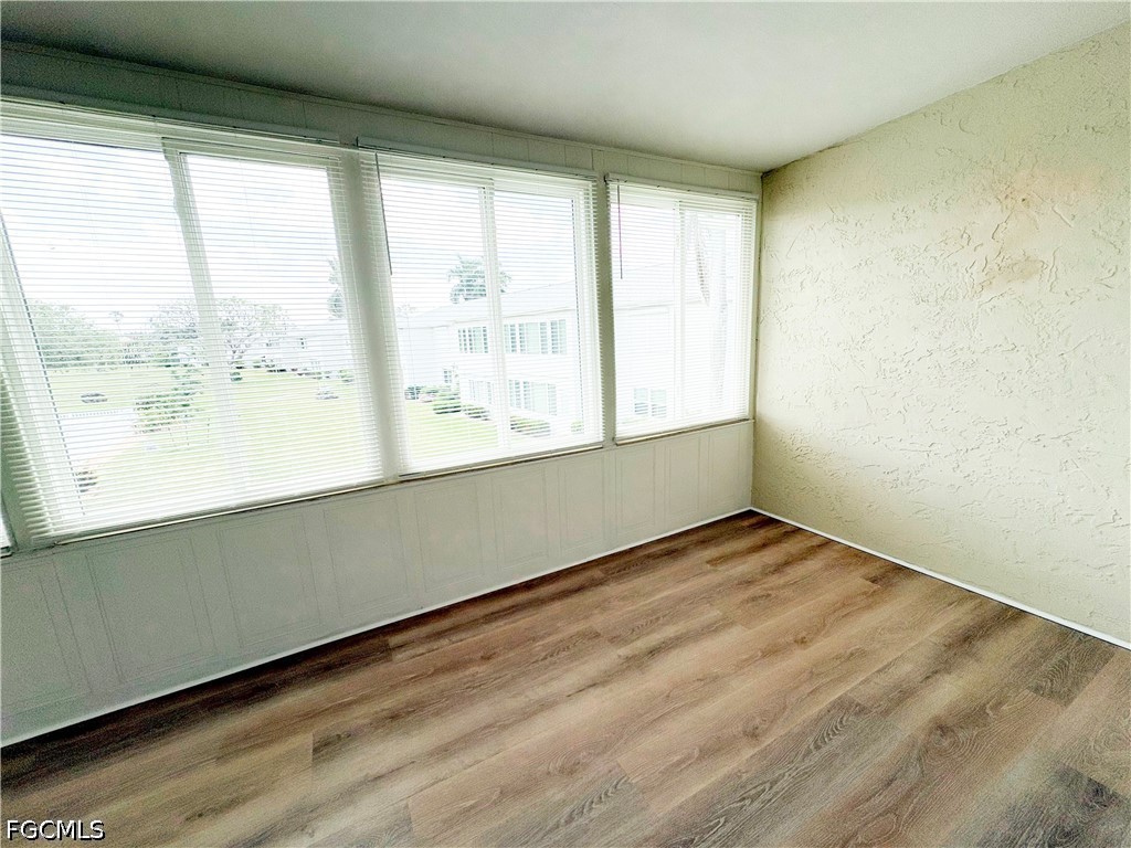 1830 Brantley Road, Unit I7 Fort Myers, FL 33907 - Photo 26 of 34 a view of an empty room with wooden floor and a window
