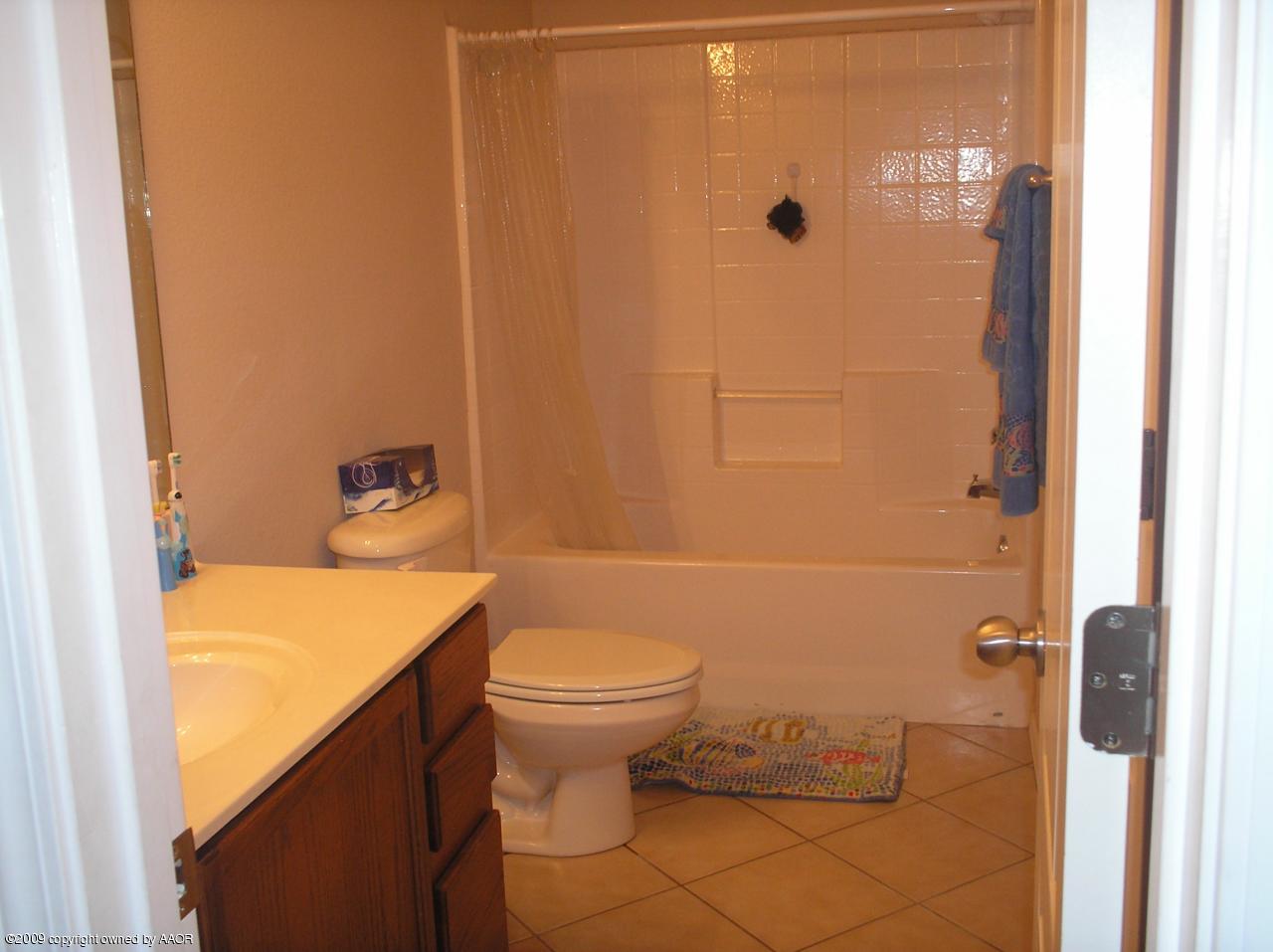 4804 Nimbus Lane Amarillo, TX 79110 - Photo 13 of 21 a bathroom with a sink toilet and shower