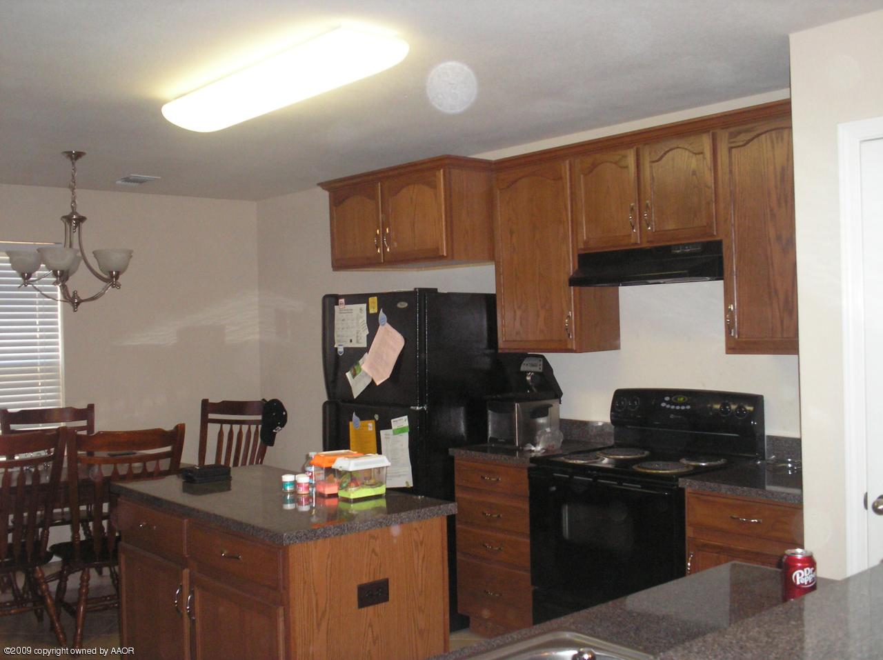 4804 Nimbus Lane Amarillo, TX 79110 - Photo 17 of 21 a kitchen with a stove and a refrigerator
