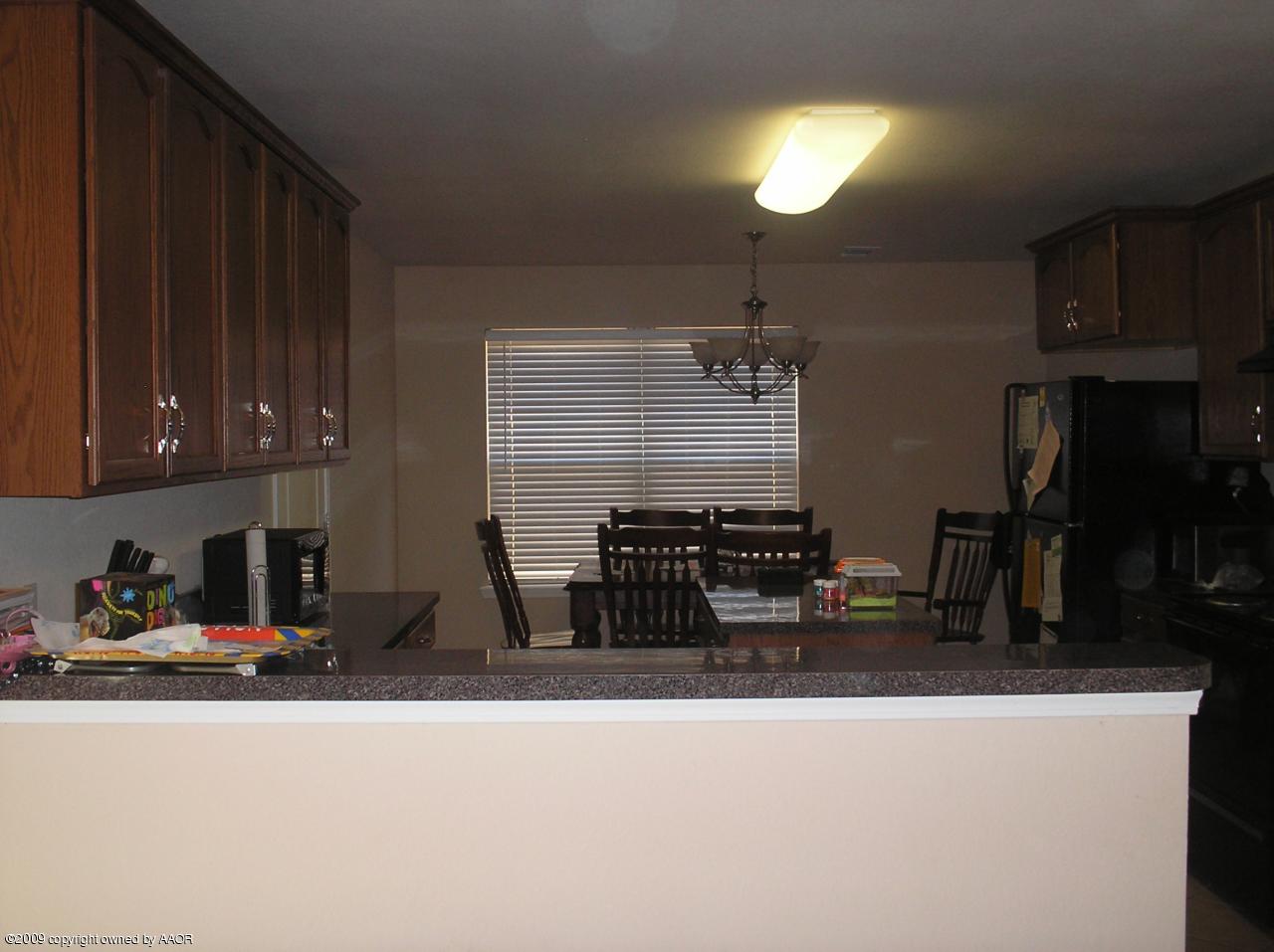 4804 Nimbus Lane Amarillo, TX 79110 - Photo 18 of 21 a kitchen with sink a refrigerator and cabinets
