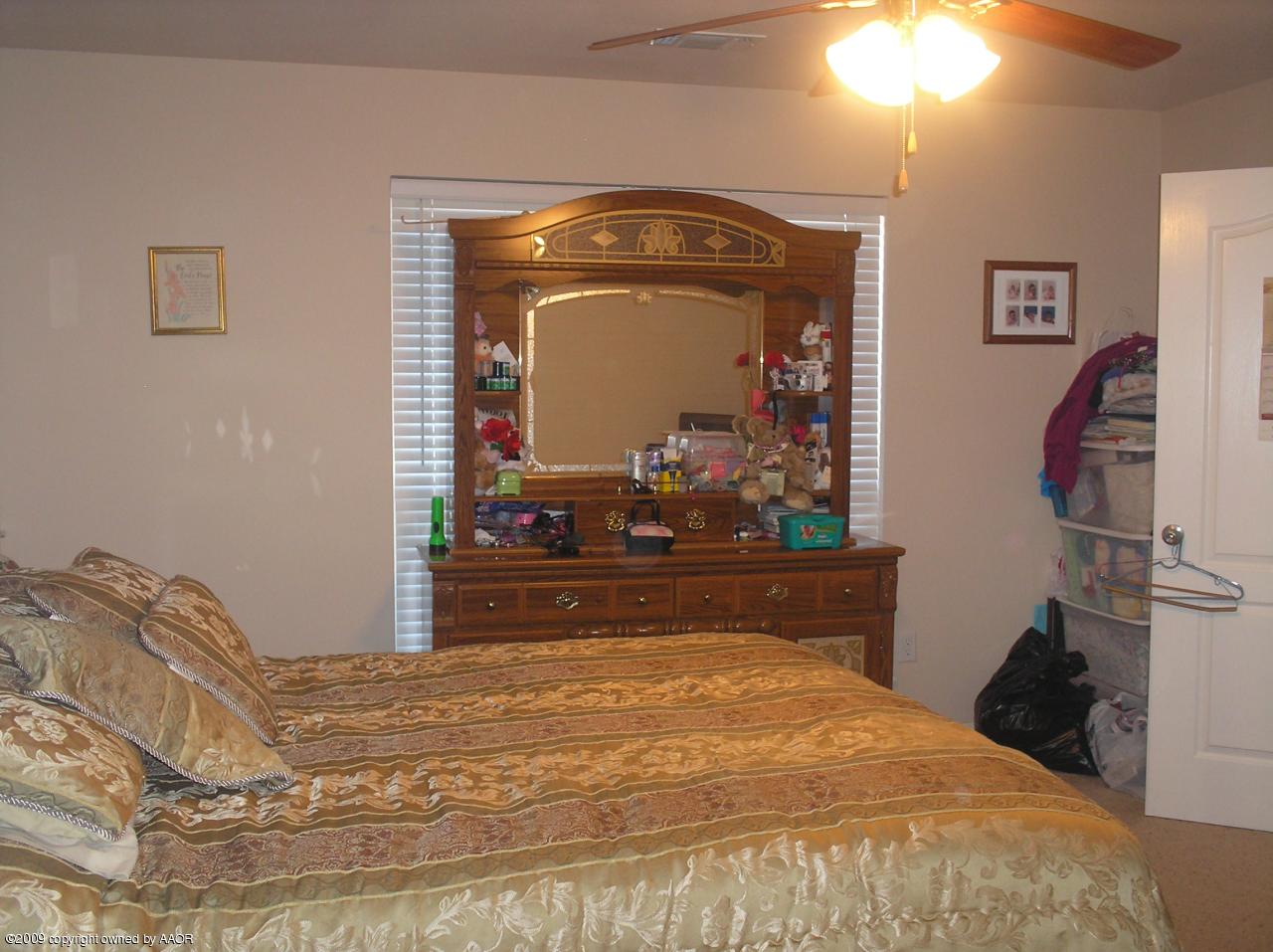 4804 Nimbus Lane Amarillo, TX 79110 - Photo 3 of 21 a bedroom with a bed and a mirror on dresser