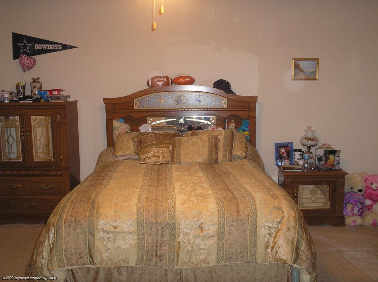 4804 Nimbus Lane Amarillo, TX 79110 - Photo 4 of 21 a bedroom with a bed and wooden floor