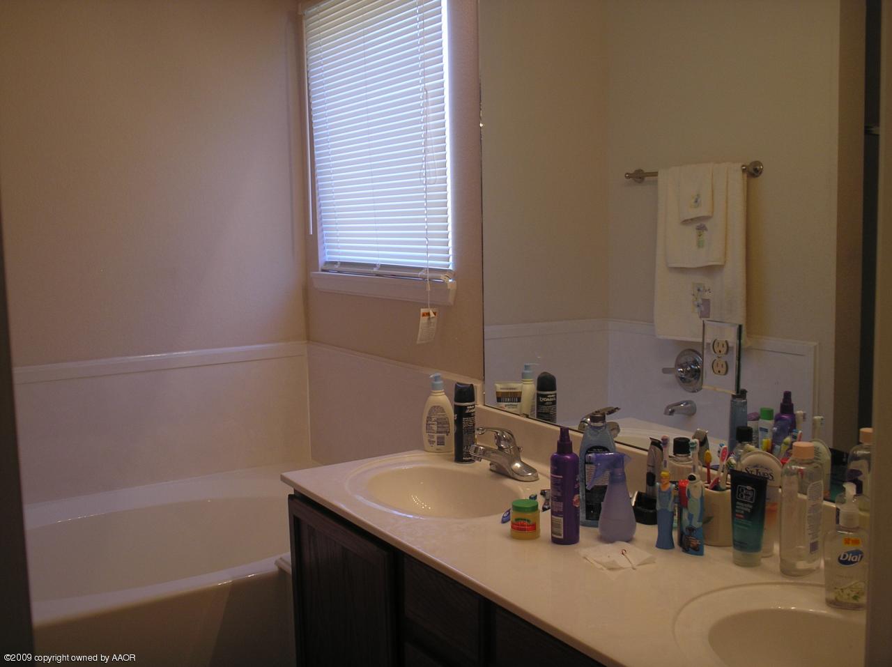 4804 Nimbus Lane Amarillo, TX 79110 - Photo 6 of 21 a bathroom with a sink and a bathtub