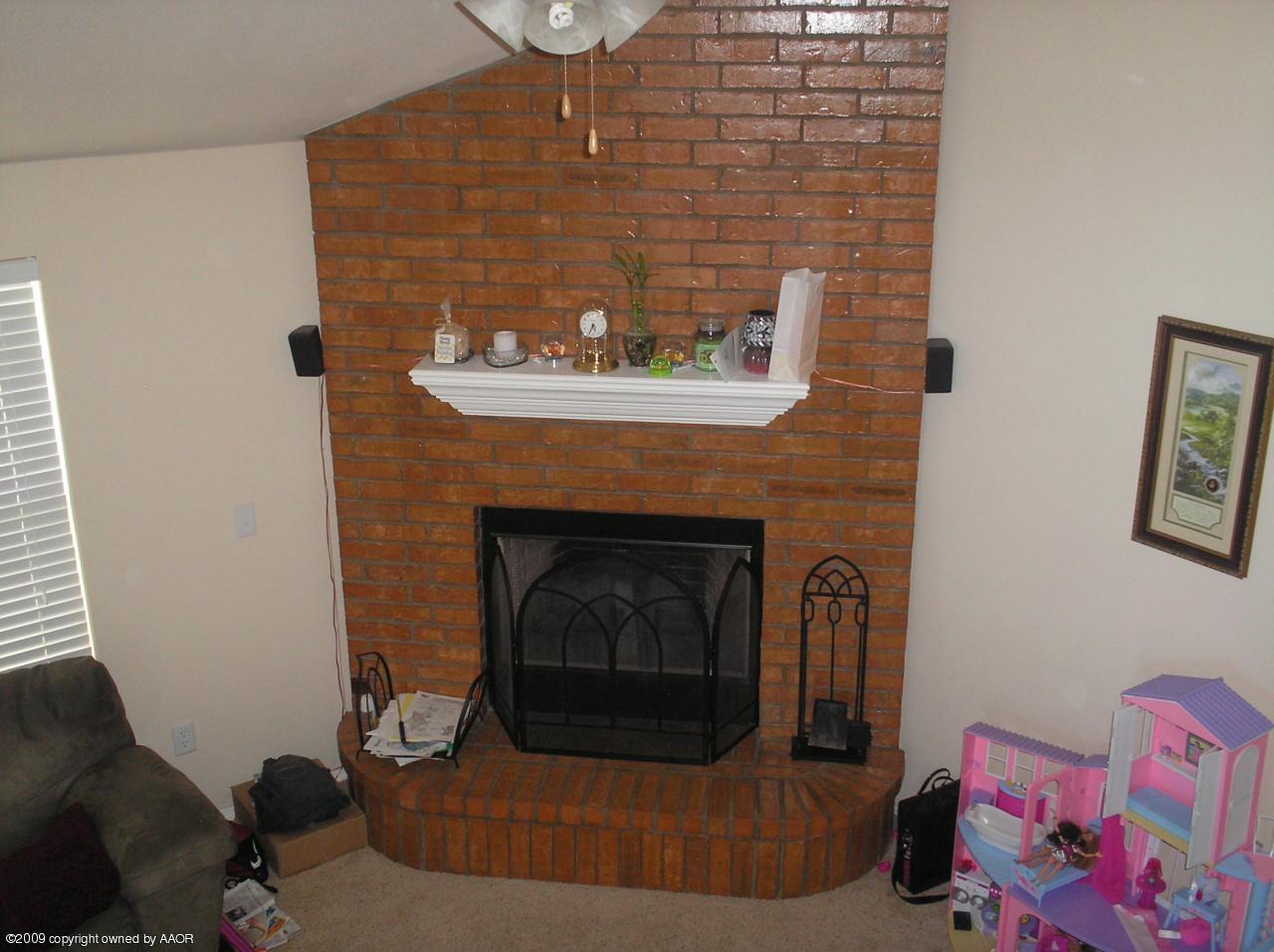 4804 Nimbus Lane Amarillo, TX 79110 - Photo 8 of 21 a living room with furniture and a fireplace