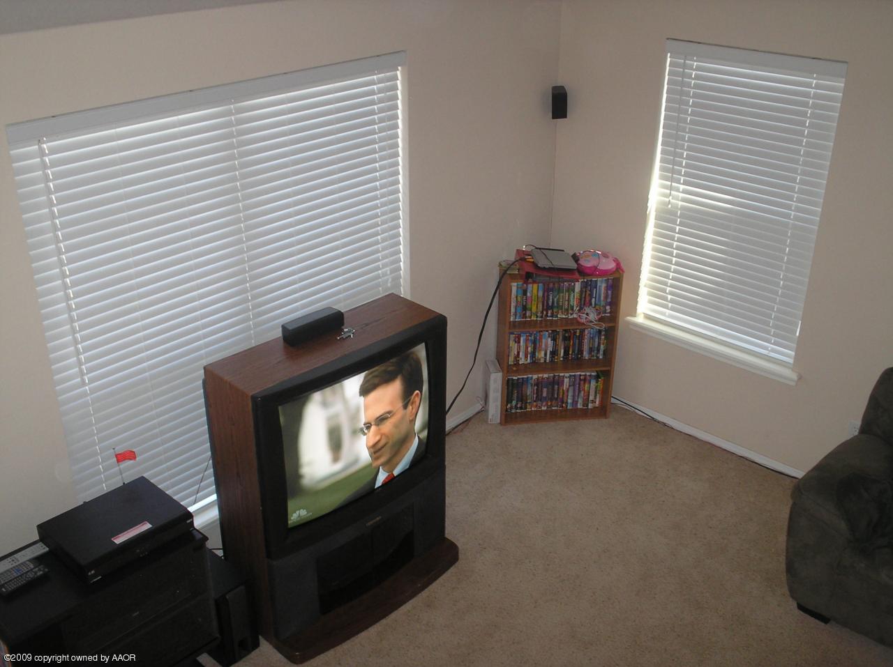 4804 Nimbus Lane Amarillo, TX 79110 - Photo 9 of 21 a view of an empty room with windows and a flat screen tv