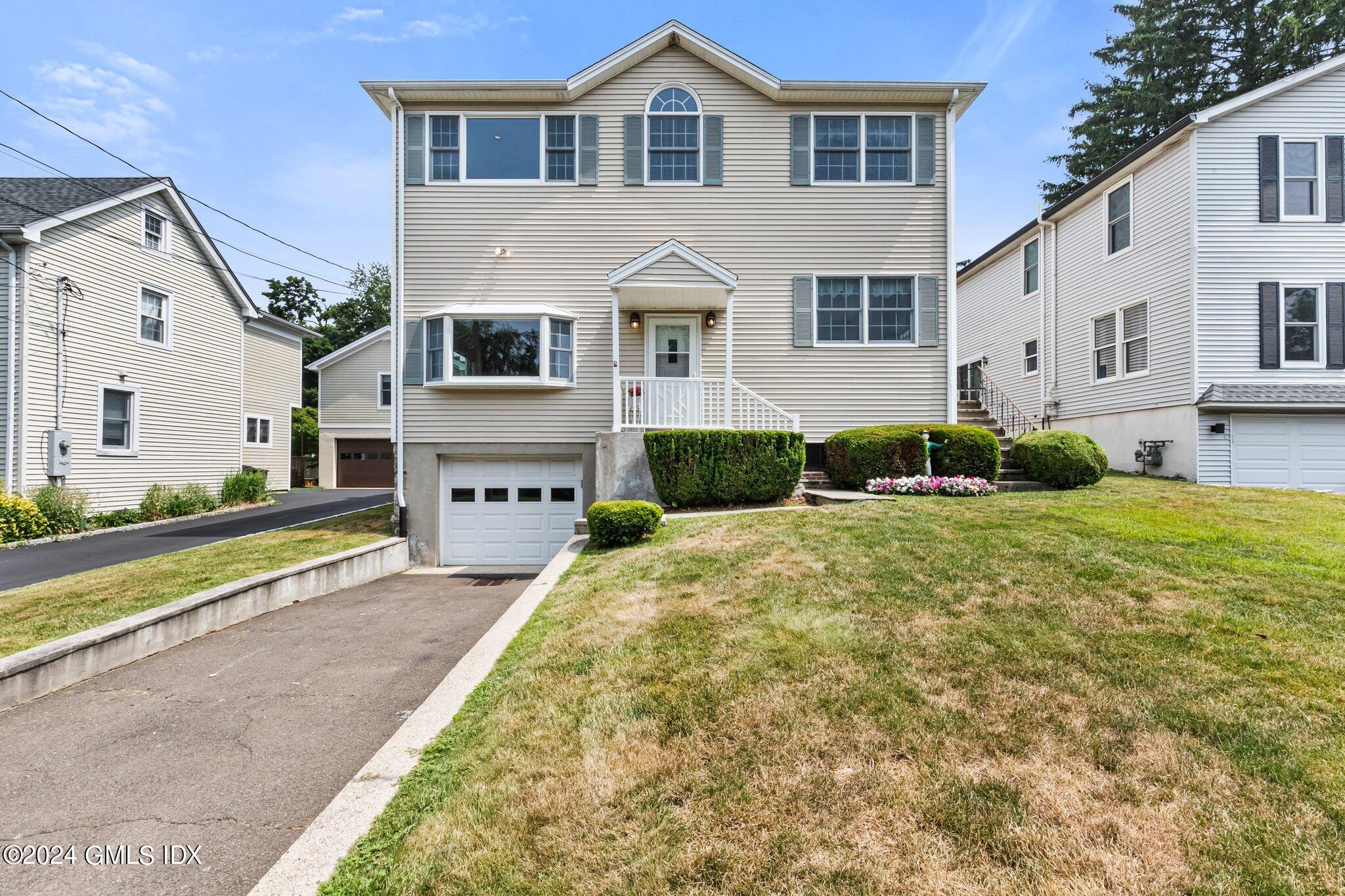 15 Thorn Hill Road Riverside, CT 06878 - Photo 1 of 30 a front view of a house with a yard