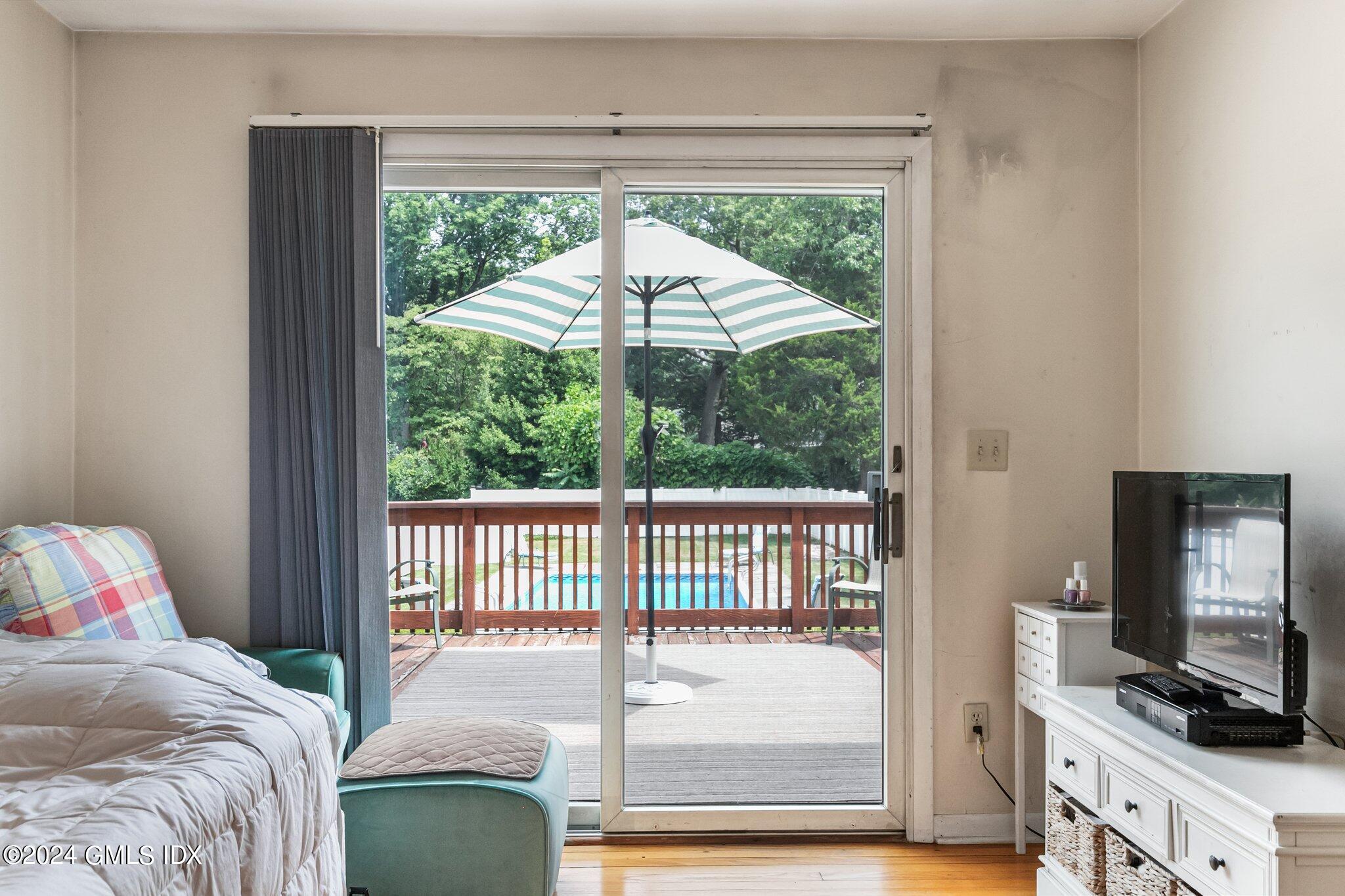 15 Thorn Hill Road Riverside, CT 06878 - Photo 13 of 30 a bedroom with a bed and a flat tv screen next to a window