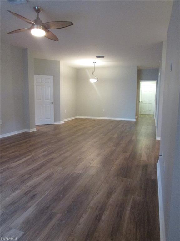 7005 Pinnacle Lane, Unit 1501 Naples, FL 34110 - Photo 11 of 45 a view of an empty room with window and wooden floor