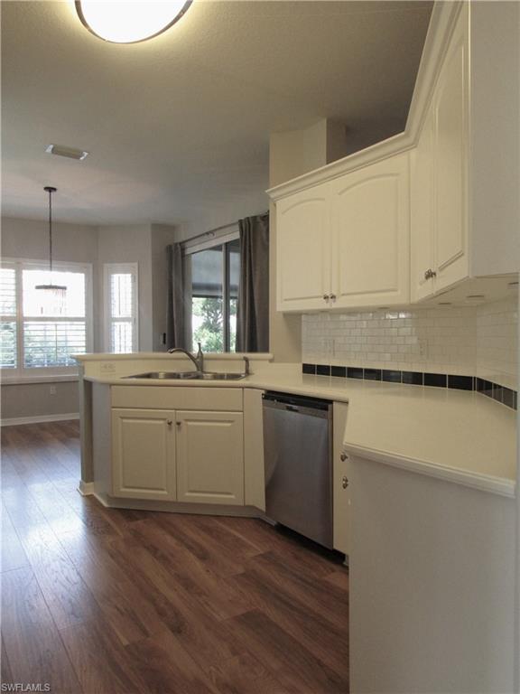 7005 Pinnacle Lane, Unit 1501 Naples, FL 34110 - Photo 13 of 45 a kitchen with granite countertop white cabinets and white appliances