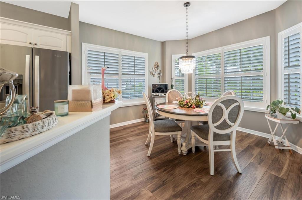 7005 Pinnacle Lane, Unit 1501 Naples, FL 34110 - Photo 16 of 45 a dining room with furniture window wooden floor