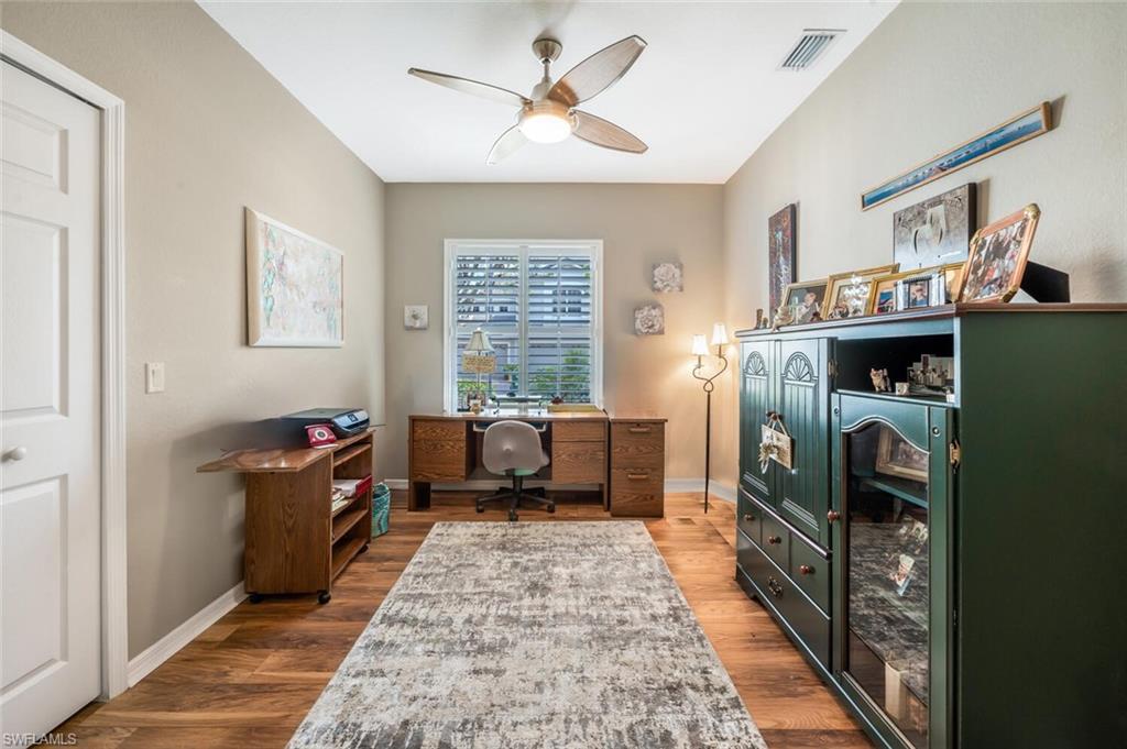 7005 Pinnacle Lane, Unit 1501 Naples, FL 34110 - Photo 22 of 45 a living room with furniture a large window with kitchen view