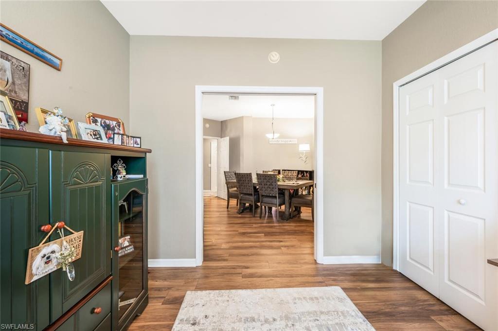 7005 Pinnacle Lane, Unit 1501 Naples, FL 34110 - Photo 23 of 45 a living room with furniture and a flat screen tv