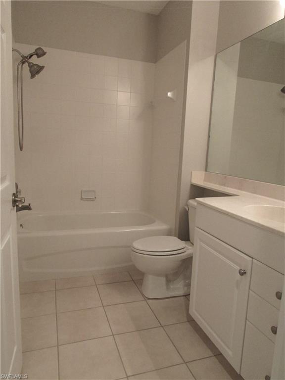 7005 Pinnacle Lane, Unit 1501 Naples, FL 34110 - Photo 28 of 45 a bathroom with a toilet a sink and shower