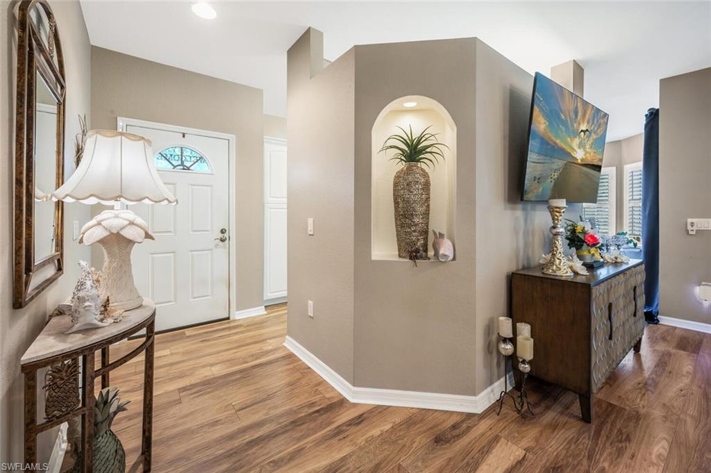 7005 Pinnacle Lane, Unit 1501 Naples, FL 34110 - Photo 3 of 45 a view of livingroom with furniture and wooden floor