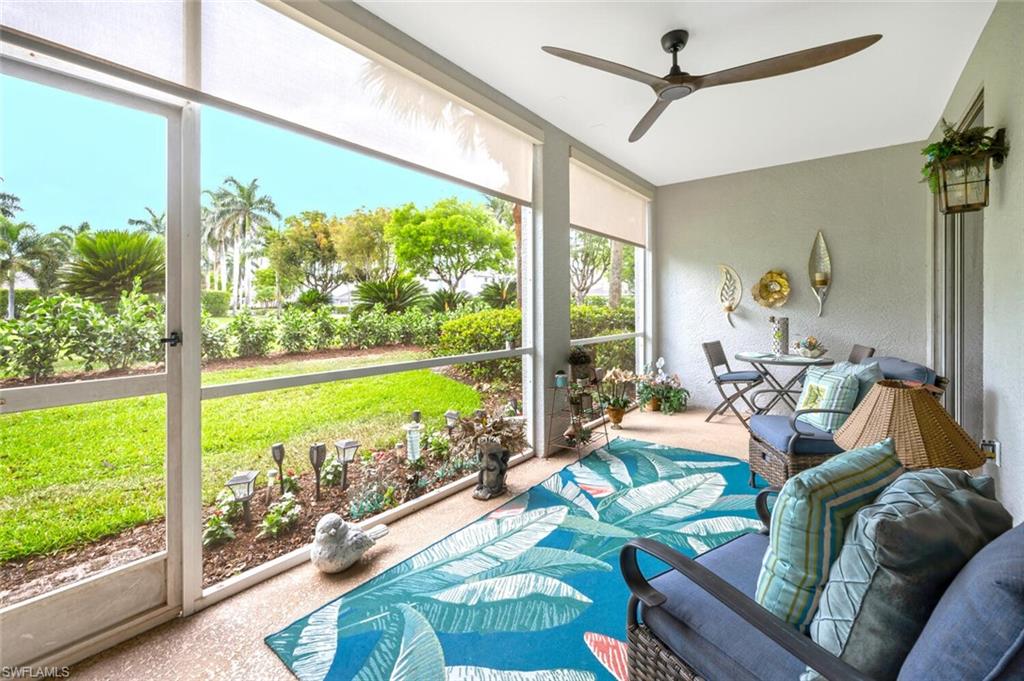 7005 Pinnacle Lane, Unit 1501 Naples, FL 34110 - Photo 31 of 45 a living room with patio furniture and a floor to ceiling window