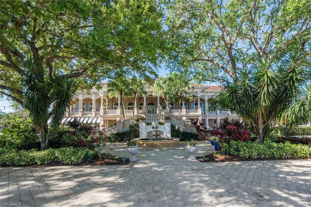 7005 Pinnacle Lane, Unit 1501 Naples, FL 34110 - Photo 33 of 45 a view of a patio with table and chairs and potted plants