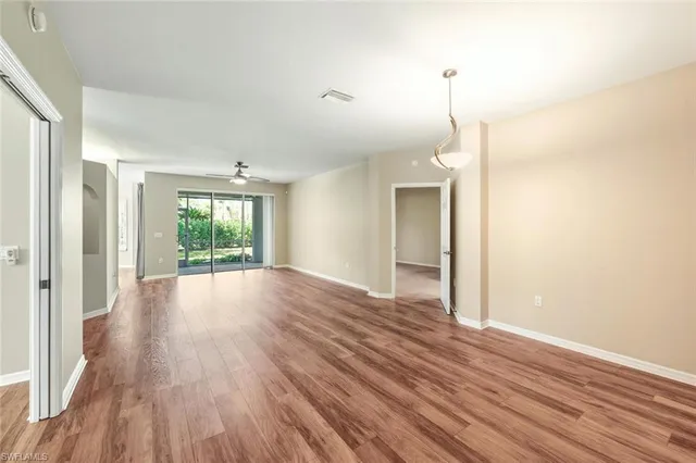 a view of a room with wooden floor and window