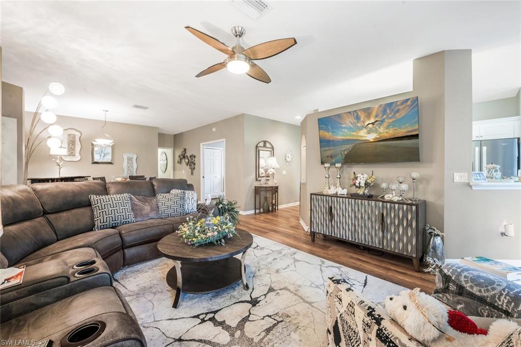 7005 Pinnacle Lane, Unit 1501 Naples, FL 34110 - Photo 7 of 45 a living room with furniture and wooden floor