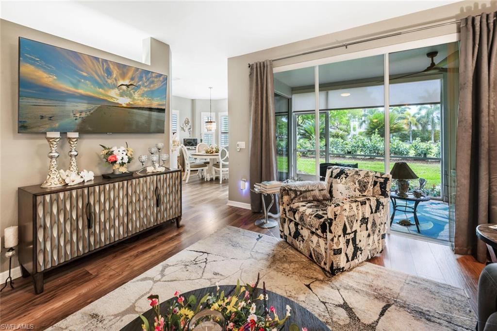 7005 Pinnacle Lane, Unit 1501 Naples, FL 34110 - Photo 8 of 45 a living room with furniture and a large window