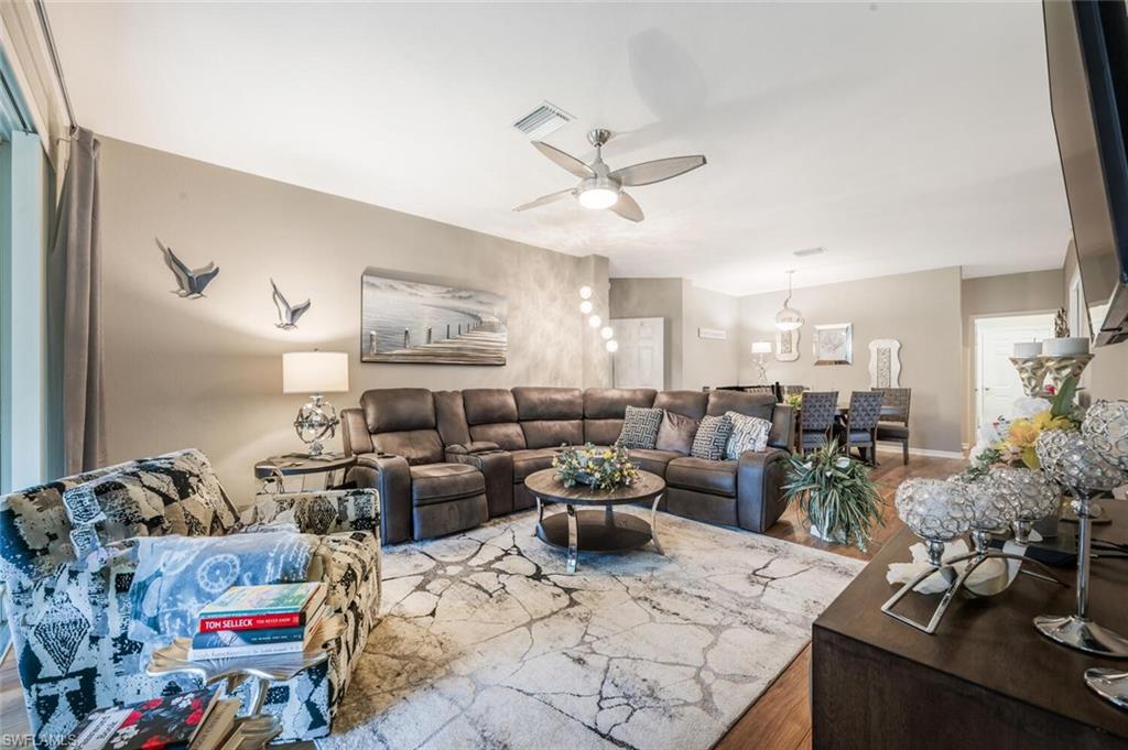 7005 Pinnacle Lane, Unit 1501 Naples, FL 34110 - Photo 9 of 45 a living room with lots of furniture and white walls