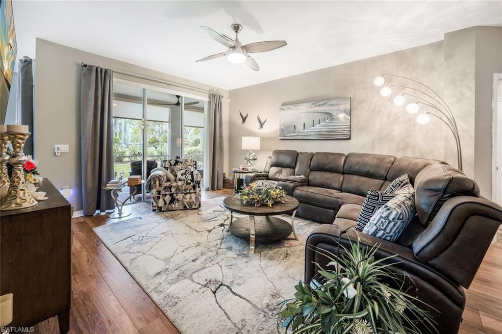7005 Pinnacle Lane, Unit 1501 Naples, FL 34110 - Photo 10 of 45 a living room with furniture and a large window