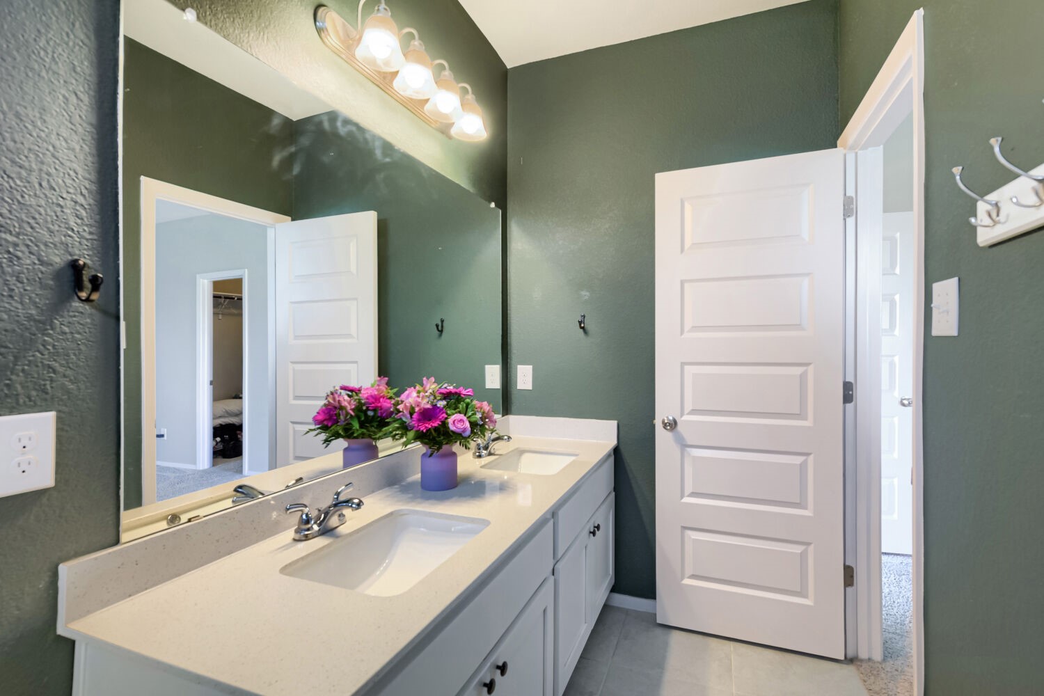1310 Goforth Road Kyle, TX 78640 - Photo 17 of 24 Dual vanity with integrated sinks and a light-toned countertop