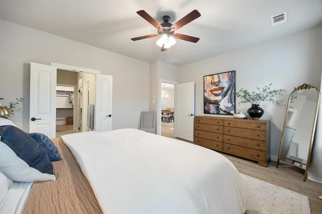 a bed room with a bed and a dresser